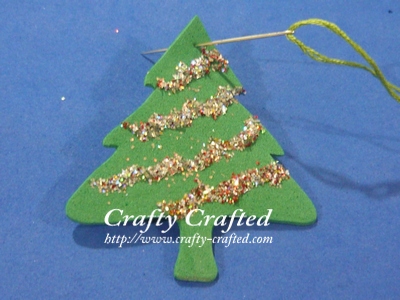 Put a needle through it and tie a knot at the end of the thread. Your Christmas tree ornament is done. So simple. :)