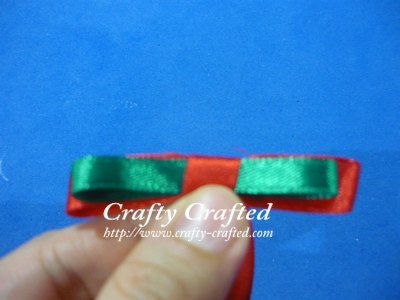 Wrap a short piece of ribbon around the middle of the two loops.